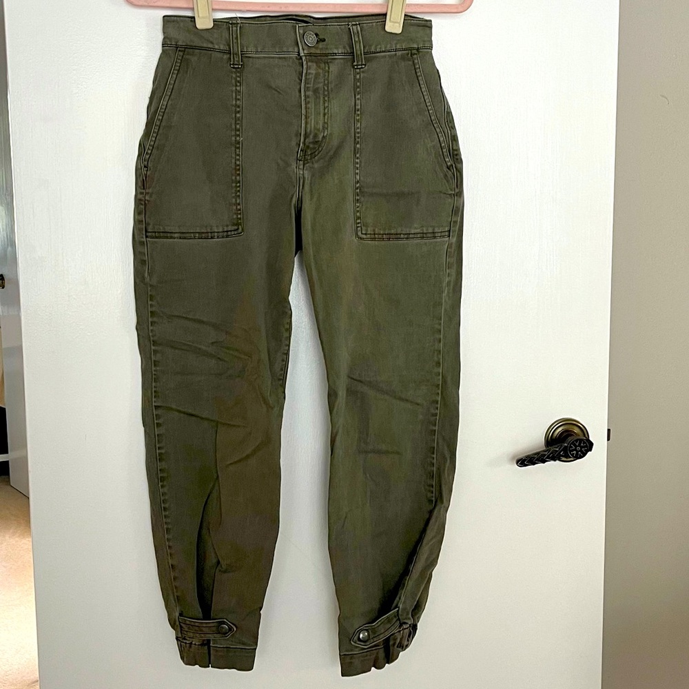Olive colored khaki style pants with snap hem